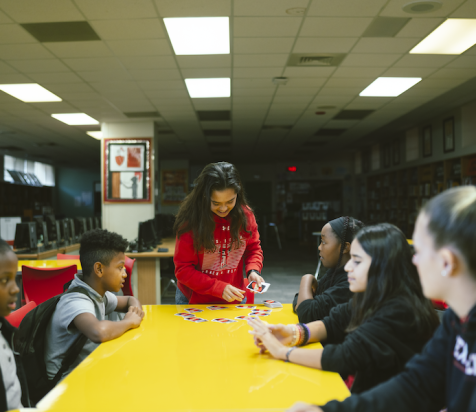 Children playing Uno with Texas Tech Students